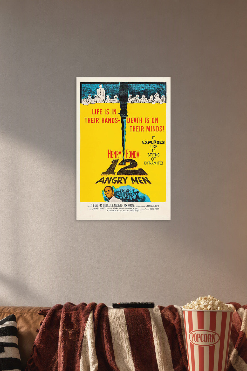 12 Angry Men movie poster in a cozy movie room above a brown sofa with popcorn.