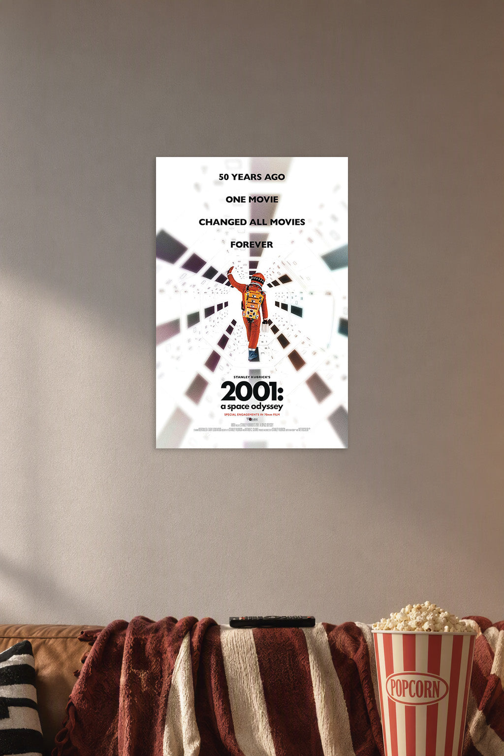 2001: A Space Odyssey Movie Poster in a cozy movie room above a brown sofa with popcorn.