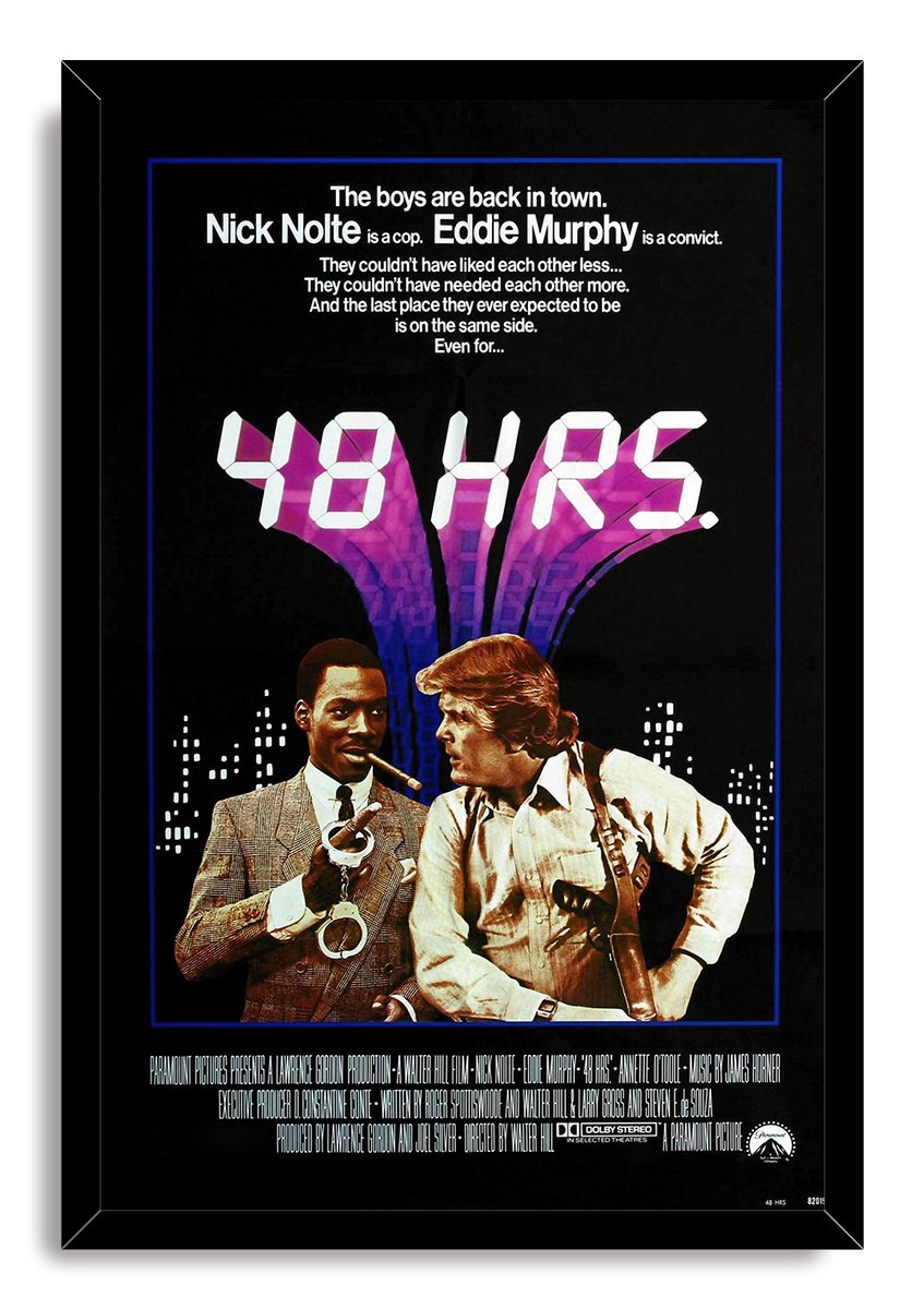 48 Hrs. framed wall art print presents Eddie Murphy and Nick Nolte beneath bold white title lettering and a purple urban backdrop.