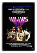 48 Hrs. framed wall art print presents Eddie Murphy and Nick Nolte beneath bold white title lettering and a purple urban backdrop.