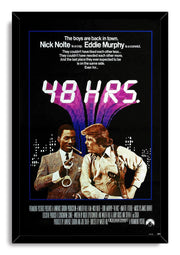 48 Hrs. framed wall art print presents Eddie Murphy and Nick Nolte beneath bold white title lettering and a purple urban backdrop.