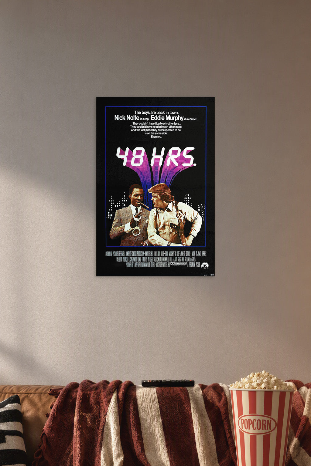 48 Hrs. Movie Poster Nick Nolte Eddie Murphy in a cozy movie room above a brown sofa with popcorn.