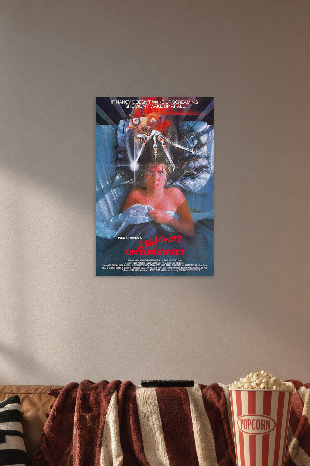 A Nightmare on Elm Street Freddy Krueger in a cozy movie room above a brown sofa with popcorn.