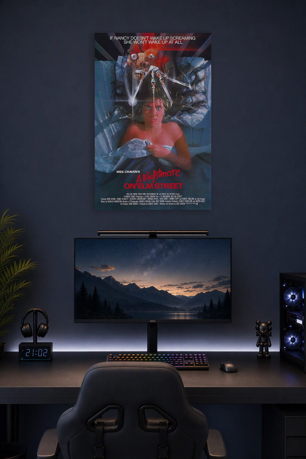 A Nightmare on Elm Street Freddy Krueger in a gaming desk setup above a monitor.