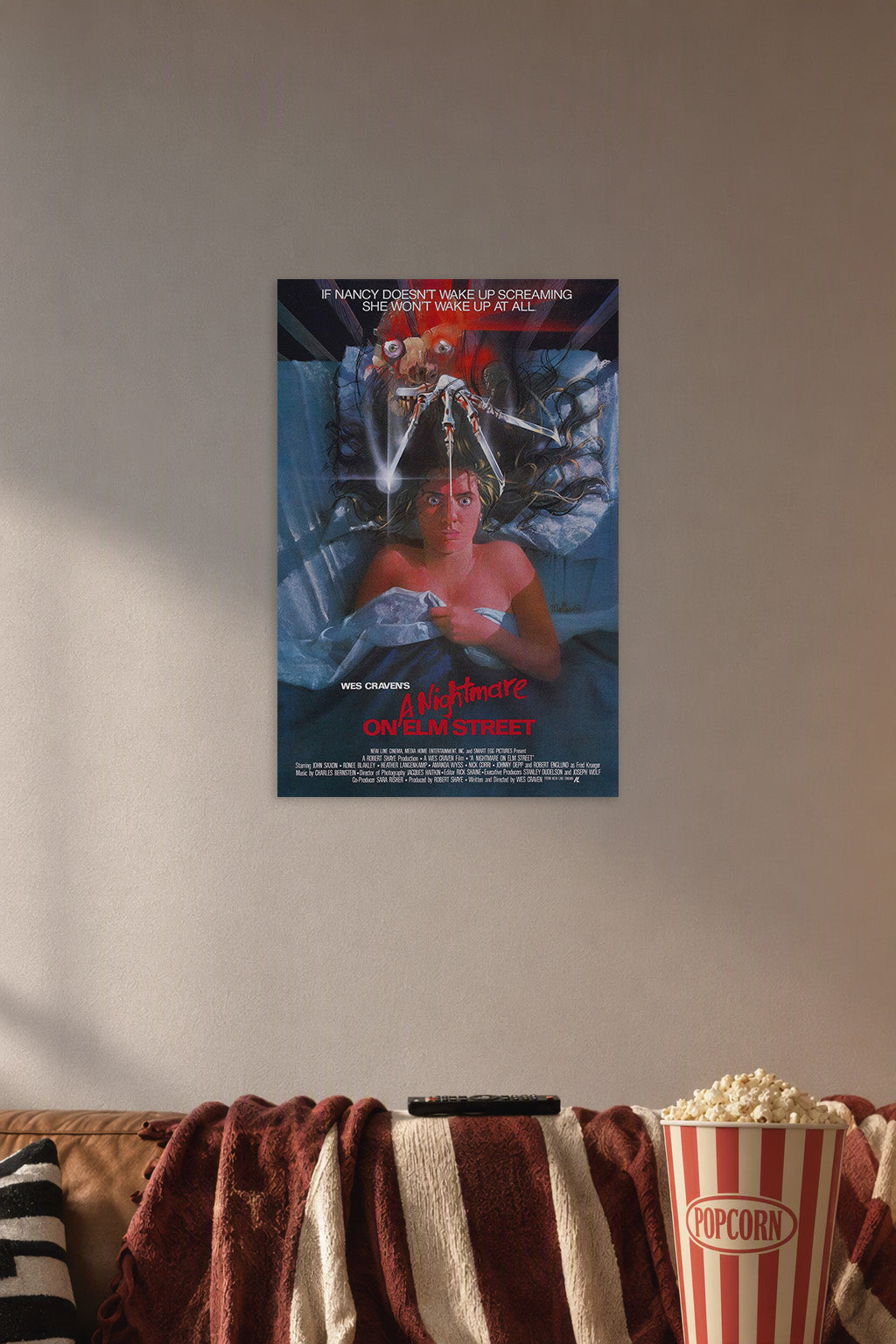 A Nightmare on Elm Street Freddy Krueger in a cozy movie room above a brown sofa with popcorn.