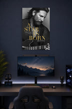 A Star Is Born Bradley Cooper in a gaming desk setup above a monitor.