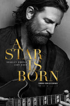 A Star Is Born poster with Bradley Cooper looking down over an electric guitar, in black and white with gold title lettering.