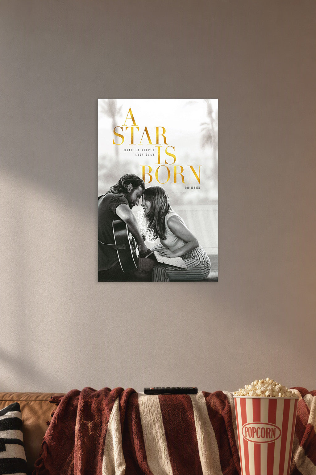 A Star Is Born Movie in a cozy movie room above a brown sofa with popcorn.