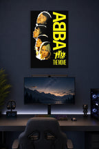 ABBA THE MOVIE in a gaming desk setup above a monitor.