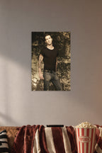 Adam Levine in a cozy movie room above a brown sofa with popcorn.
