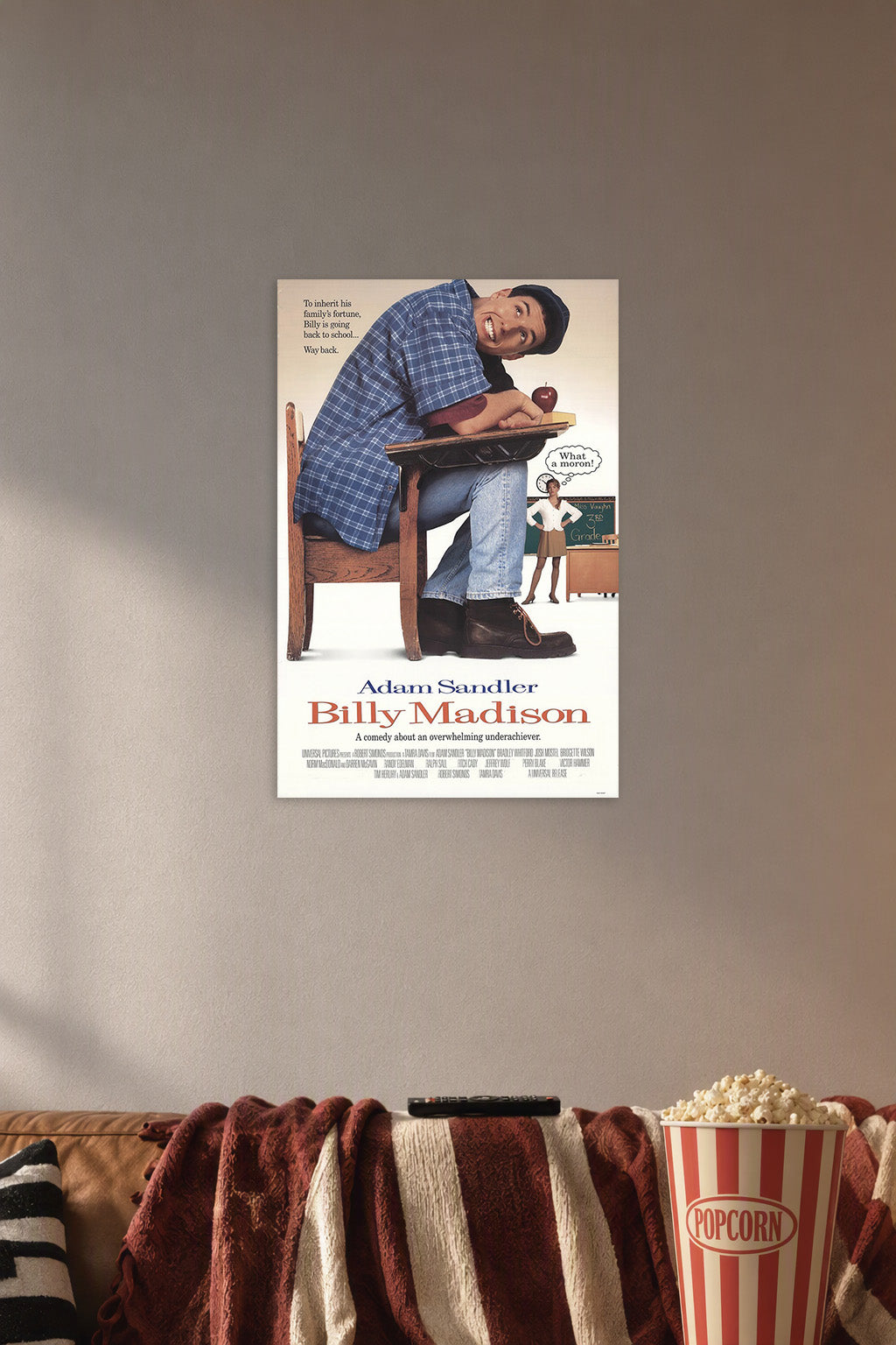 Adam Sandler Billy Madison in a cozy movie room above a brown sofa with popcorn.