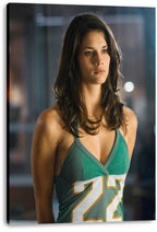 Adrianne Palicki canvas wall art print featuring her in a green number 22 jersey against a dim, blurred blue-gray backdrop.