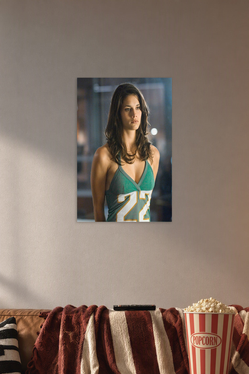 Adrianne Palicki in a cozy movie room above a brown sofa with popcorn.