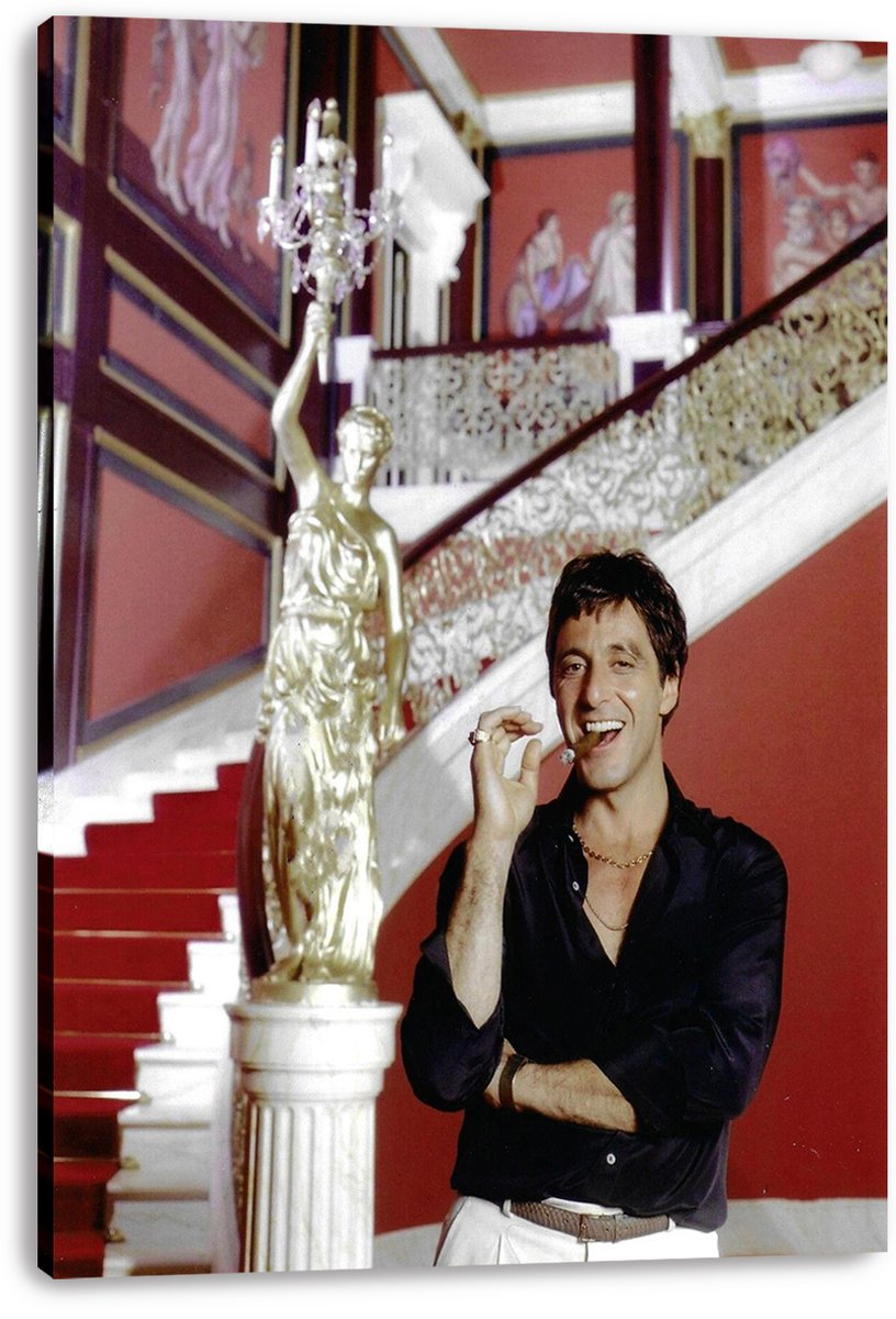 Tony Montana canvas wall art print depicts Al Pacino holding a cigar before a red staircase, ornate railings, and gold statue.