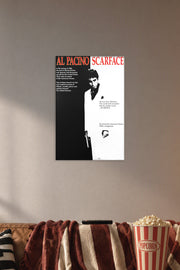 Al Pacino Scarface Tony Montana in a cozy movie room above a brown sofa with popcorn.