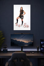 Alex Morgan in a gaming desk setup above a monitor.