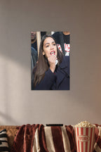 Alexandria Ocasio-Cortez in a cozy movie room above a brown sofa with popcorn.