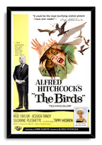 The Birds movie poster wall art print in a black frame features a screaming woman, flying birds, yellow credits, and Hitchcock.