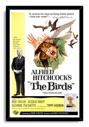 The Birds movie poster wall art print in a black frame features a screaming woman, flying birds, yellow credits, and Hitchcock.
