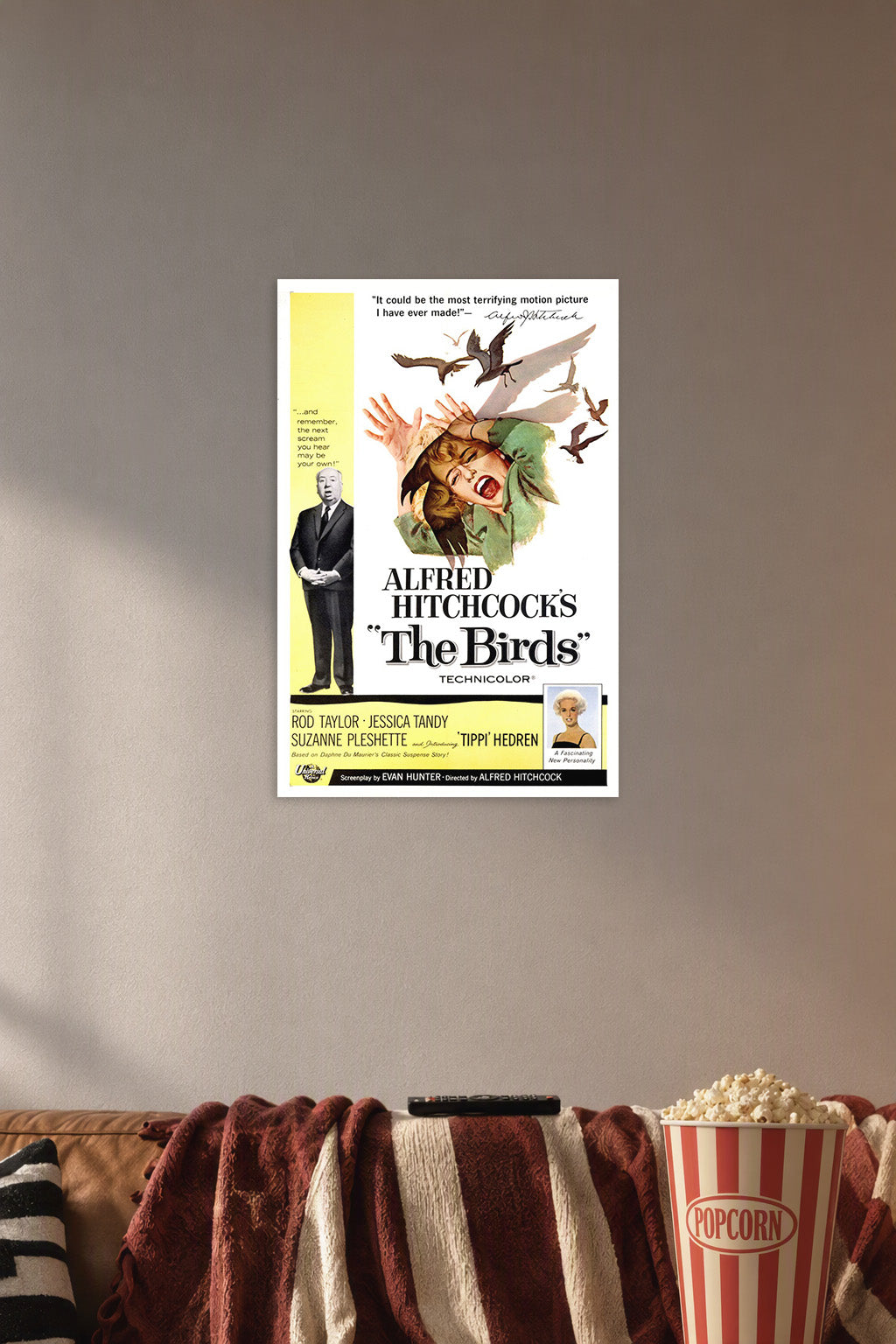 Alfred Hitchcock's The Birds Movie Poster in a cozy movie room above a brown sofa with popcorn.