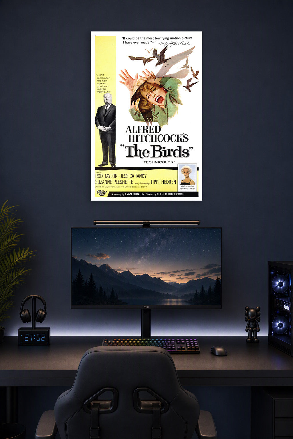 Alfred Hitchcock's The Birds Movie Poster in a gaming desk setup above a monitor.