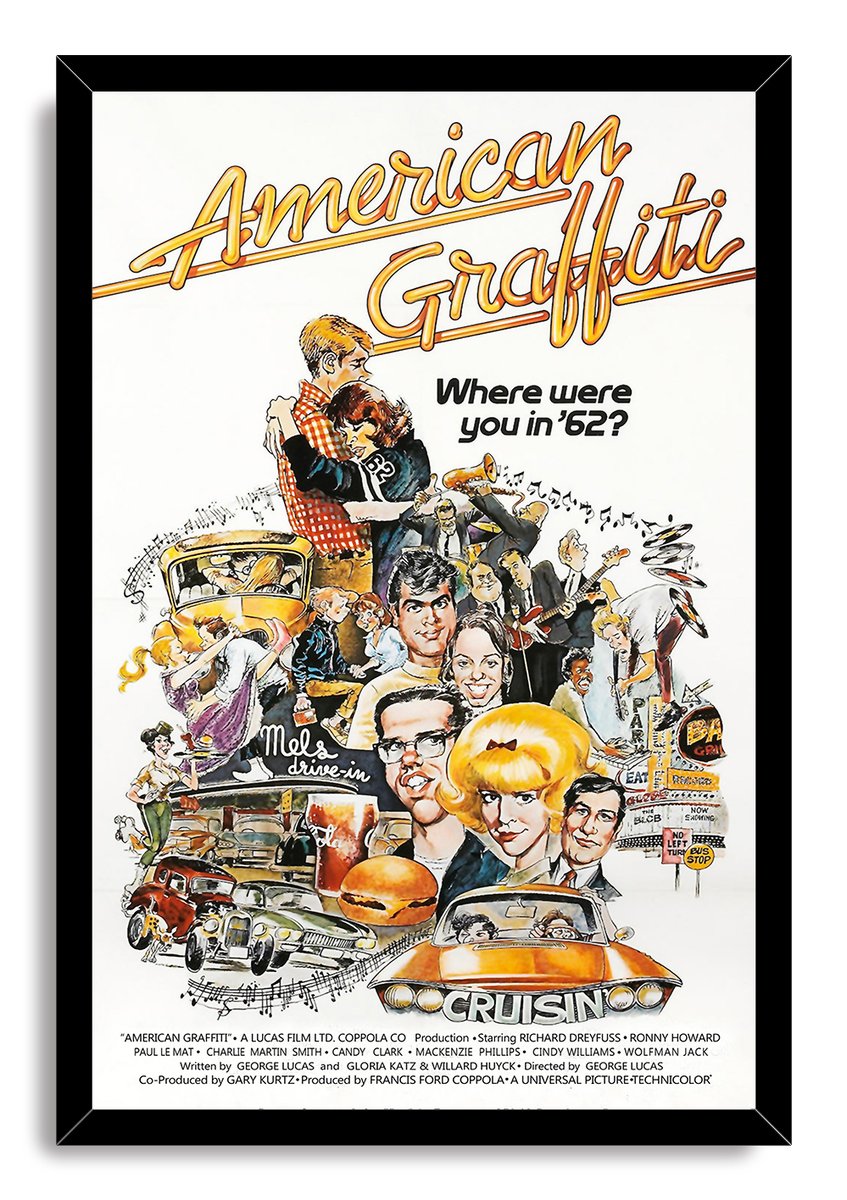 American Graffiti framed wall art print in a black frame, featuring a retro collage of characters, classic cars, diner details, and orange cruiser.