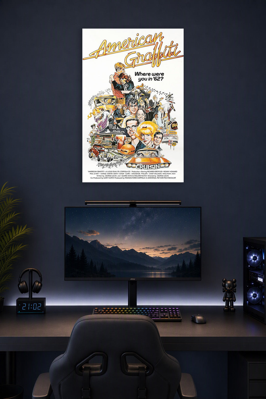 American Graffiti Movie Poster in a gaming desk setup above a monitor.