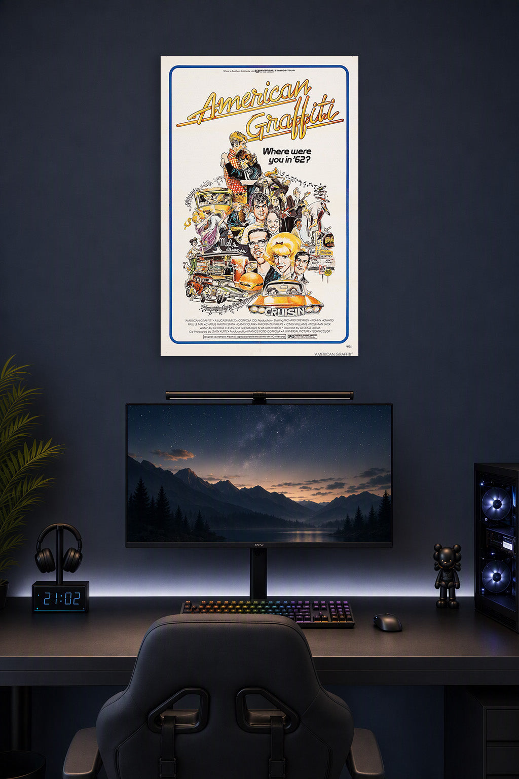American Graffiti Movie Poster in a gaming desk setup above a monitor.