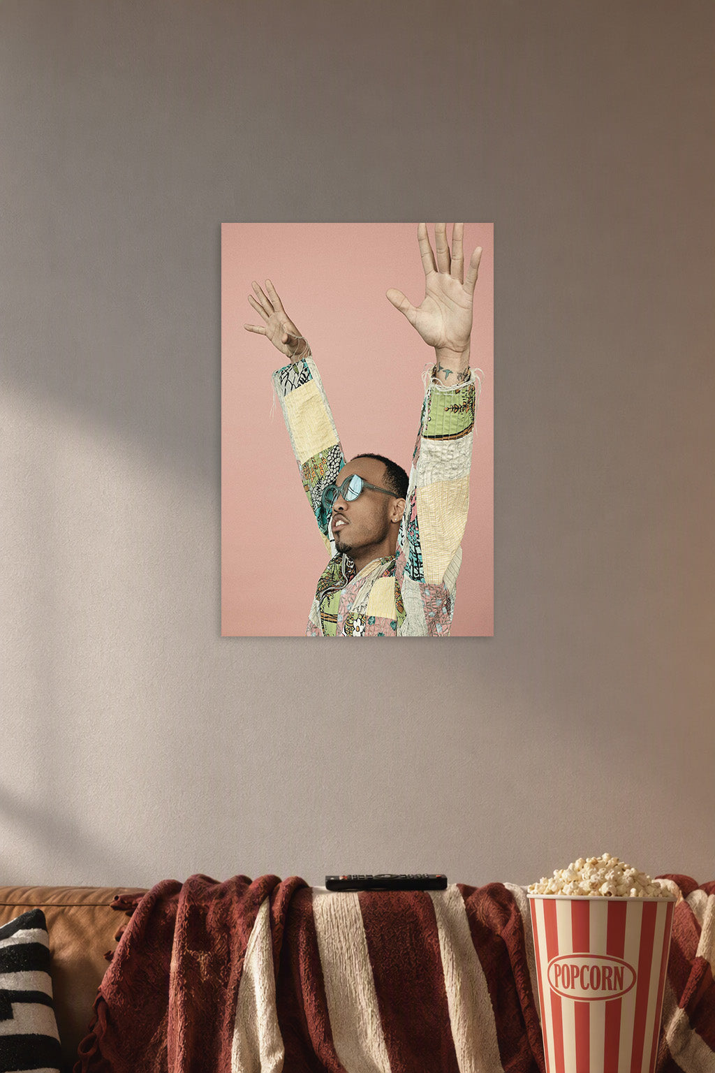 Anderson .Paak in a cozy movie room above a brown sofa with popcorn.