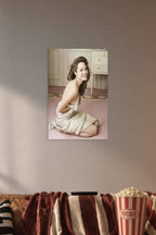 Angelina Jolie in a cozy movie room above a brown sofa with popcorn.
