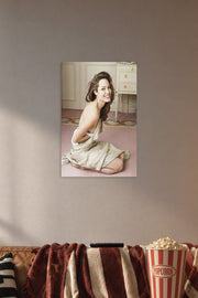 Angelina Jolie in a cozy movie room above a brown sofa with popcorn.