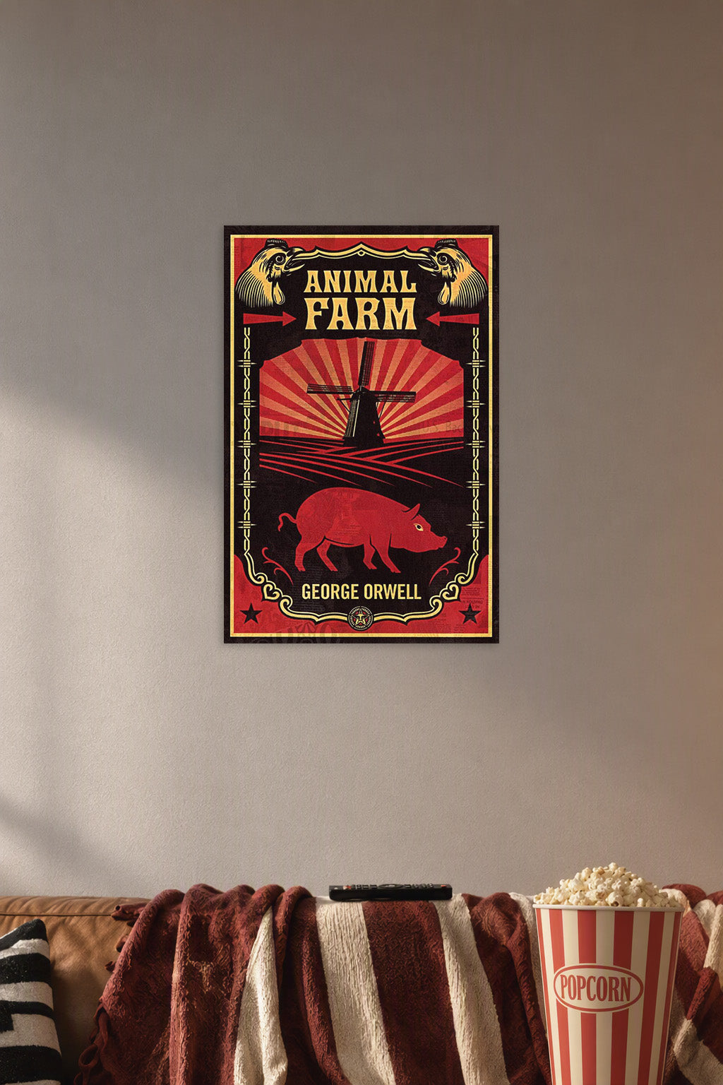Animal Farm in a cozy movie room above a brown sofa with popcorn.