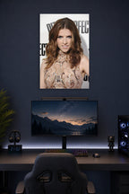 Anna Kendrick in a gaming desk setup above a monitor.