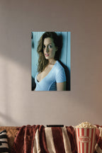 Anne Hathaway in a cozy movie room above a brown sofa with popcorn.