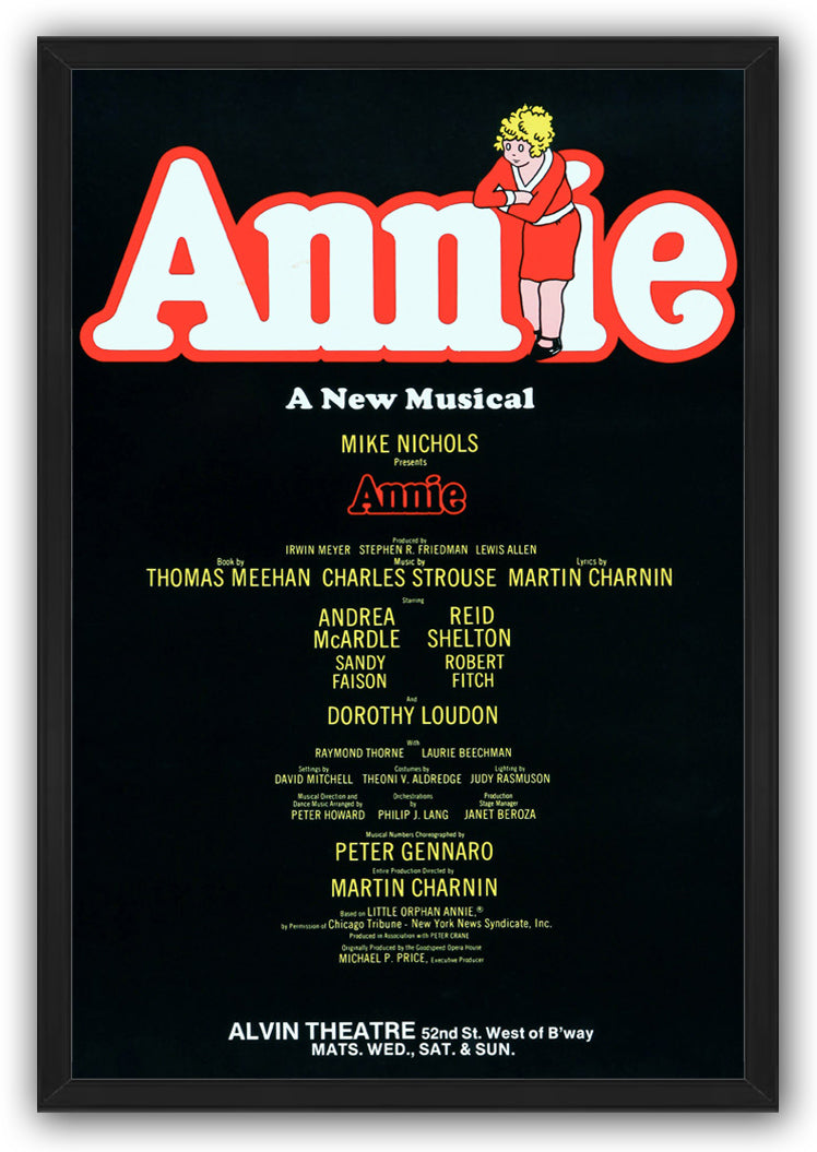 Annie framed wall art print with a black border, large red-outlined white title, curly-haired girl, and theater billing text.