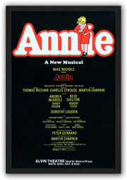 Annie framed wall art print with a black border, large red-outlined white title, curly-haired girl, and theater billing text.