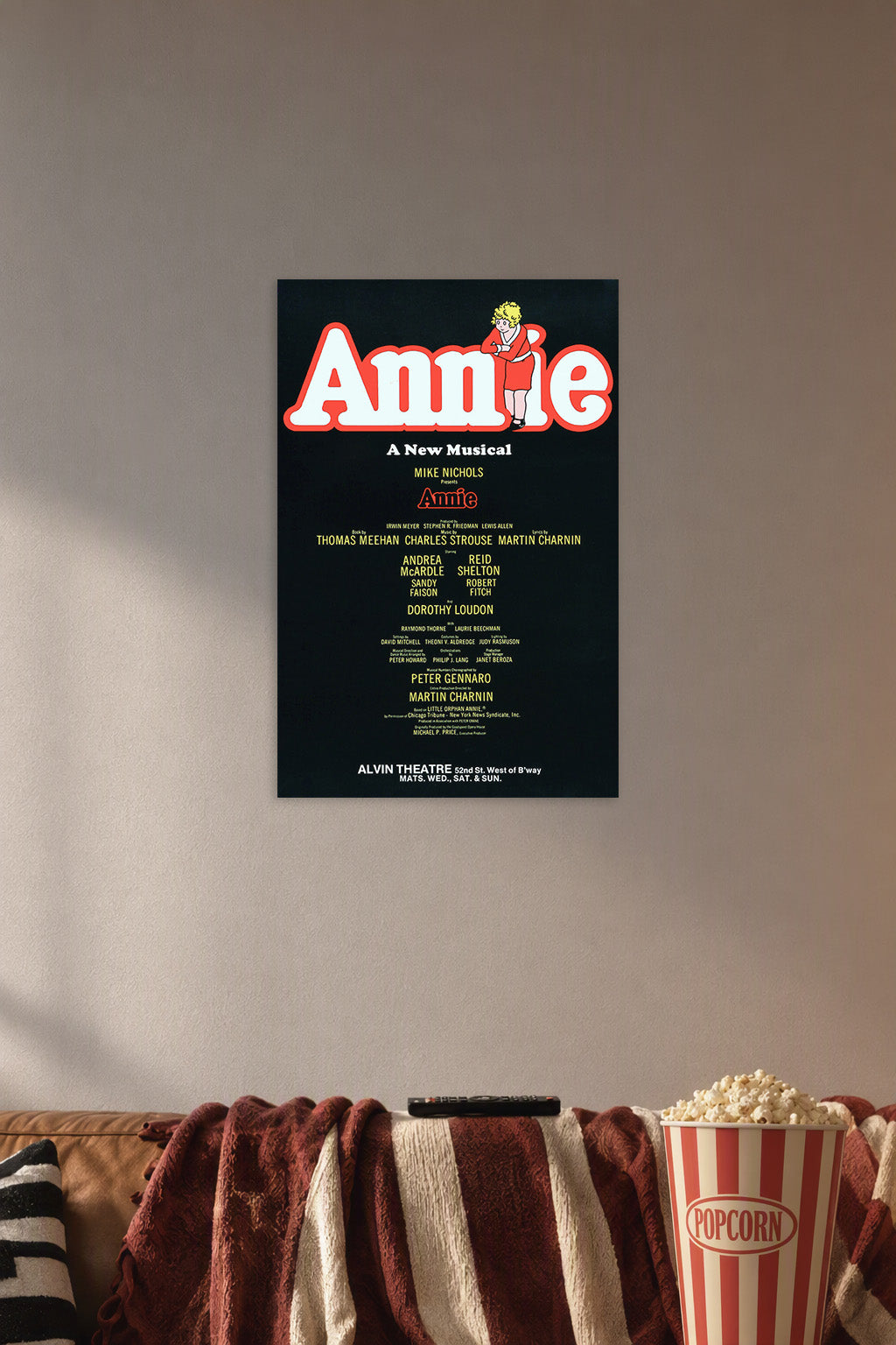 Annie Movies in a cozy movie room above a brown sofa with popcorn.