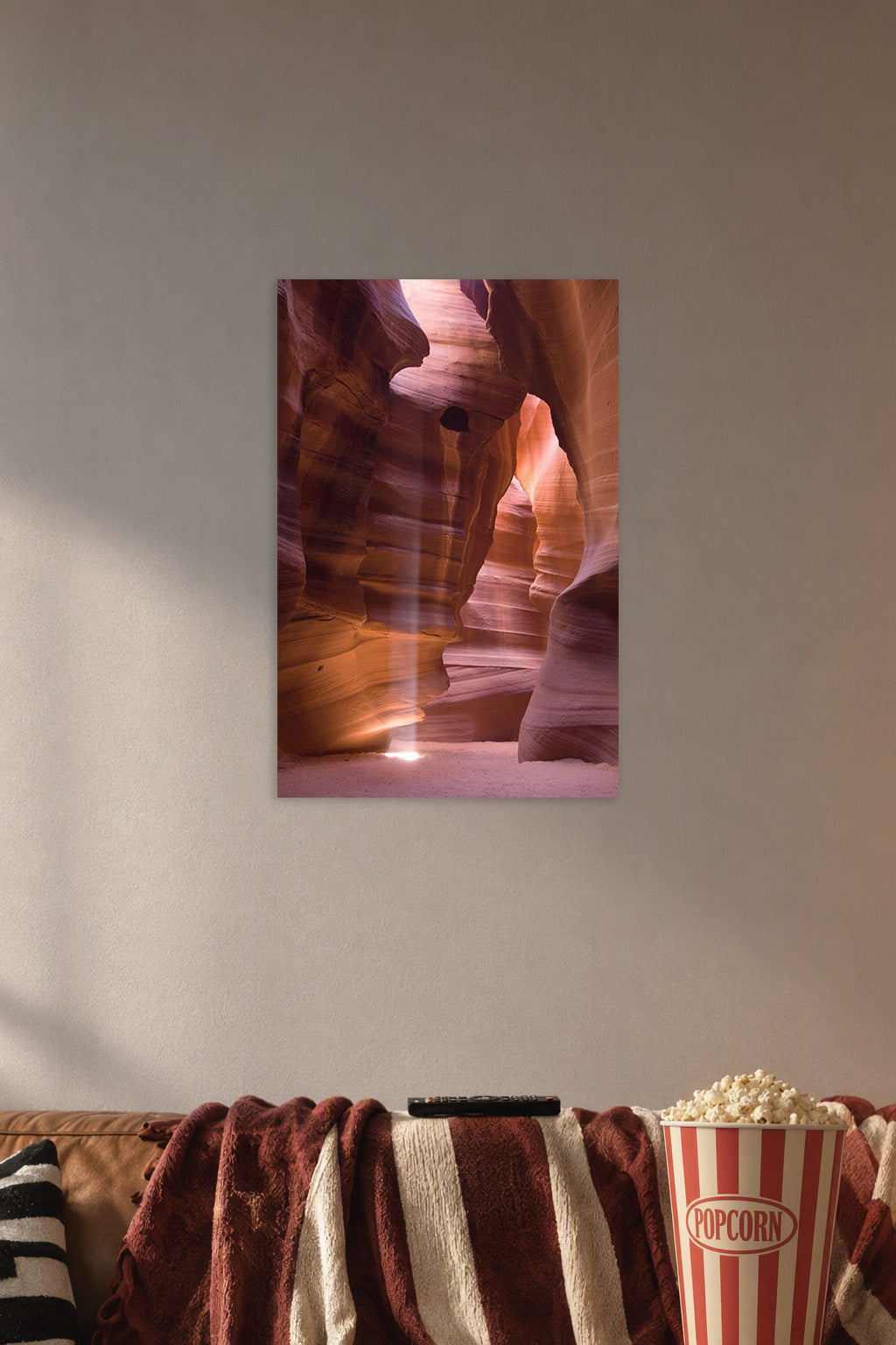 Antelope Canyon in a cozy movie room above a brown sofa with popcorn.