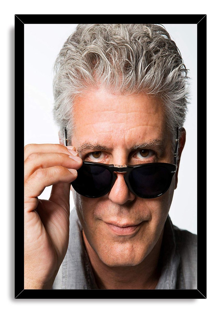 Anthony Bourdain framed wall art print with a black border, depicting his close-up portrait adjusting dark sunglasses.