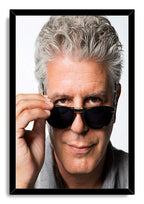Anthony Bourdain framed wall art print with a black border, depicting his close-up portrait adjusting dark sunglasses.