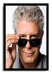 Anthony Bourdain framed wall art print with a black border, depicting his close-up portrait adjusting dark sunglasses.