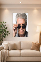 Anthony Bourdain in a bright living room above a beige sofa.