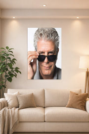 Anthony Bourdain in a bright living room above a beige sofa.
