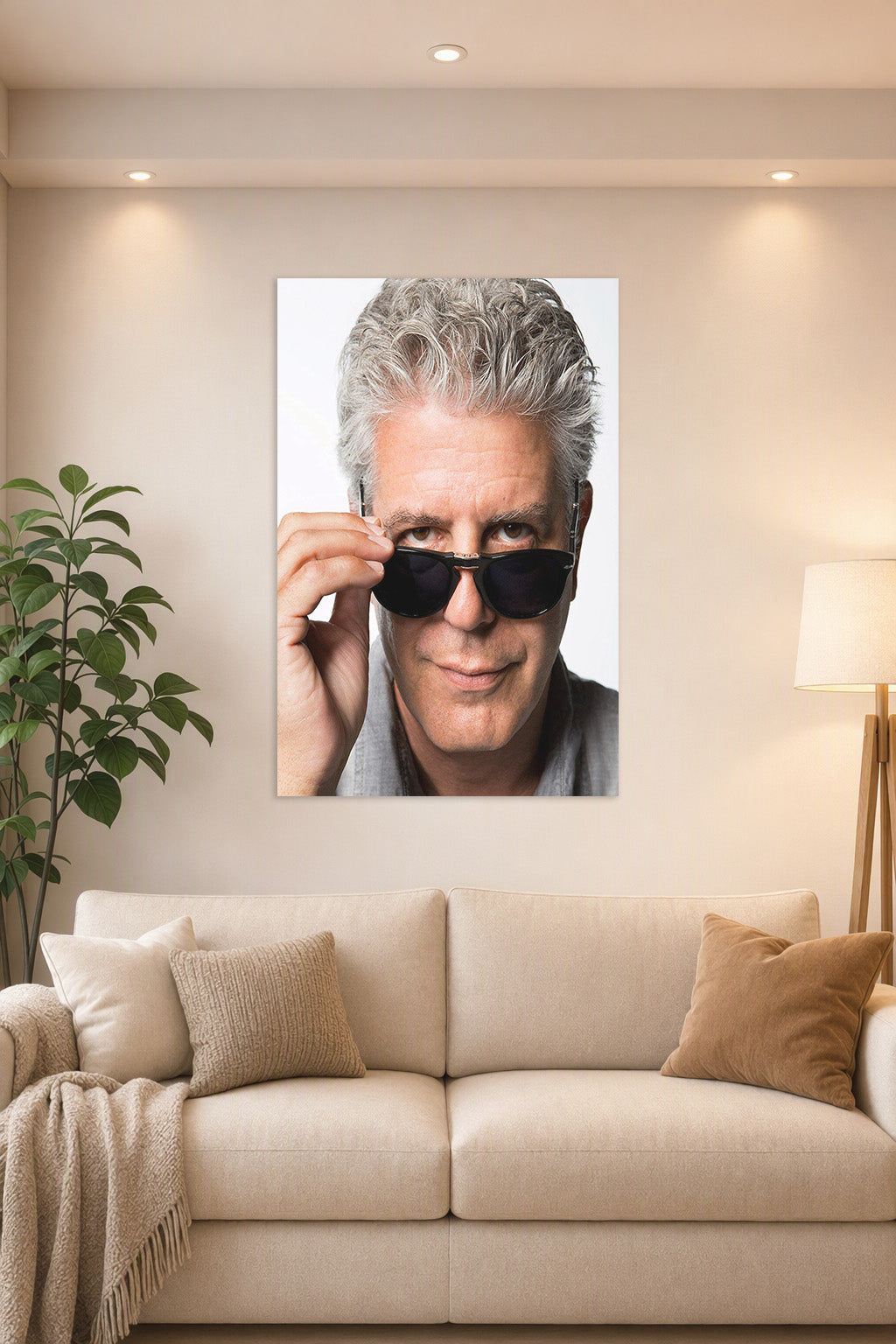 Anthony Bourdain in a bright living room above a beige sofa.