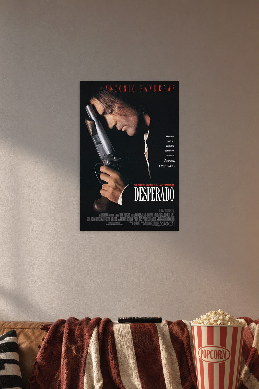 Antonio Banderas Desperado in a cozy movie room above a brown sofa with popcorn.