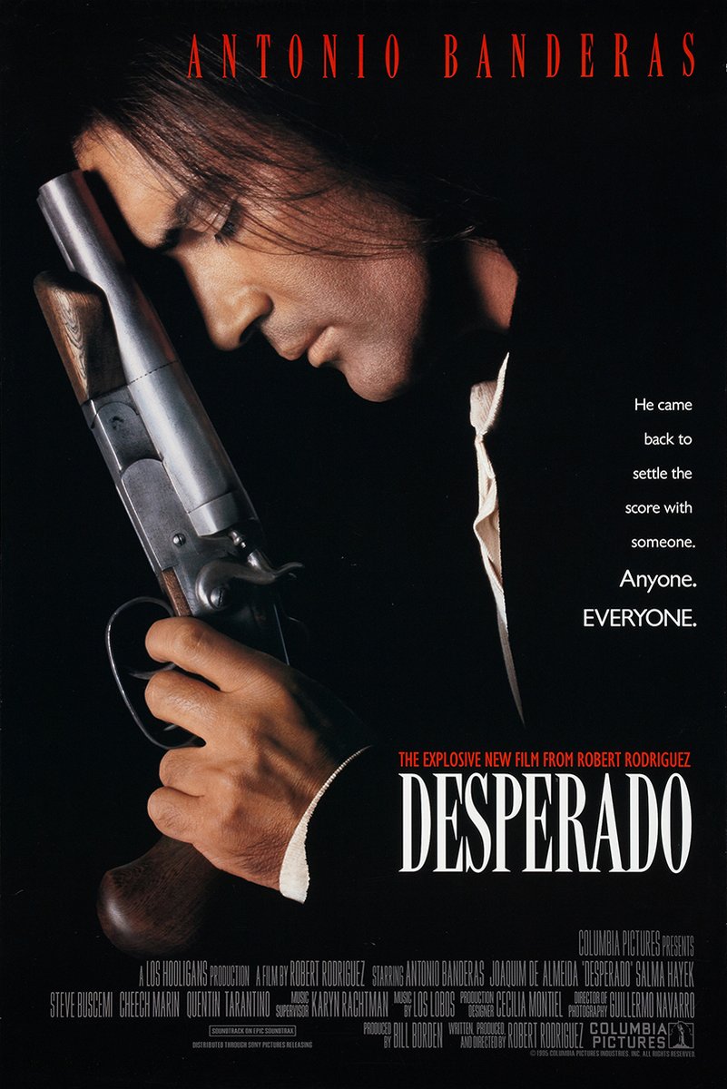 Desperado movie poster wall art print with Antonio Banderas holding a shotgun against a black background and red lettering.