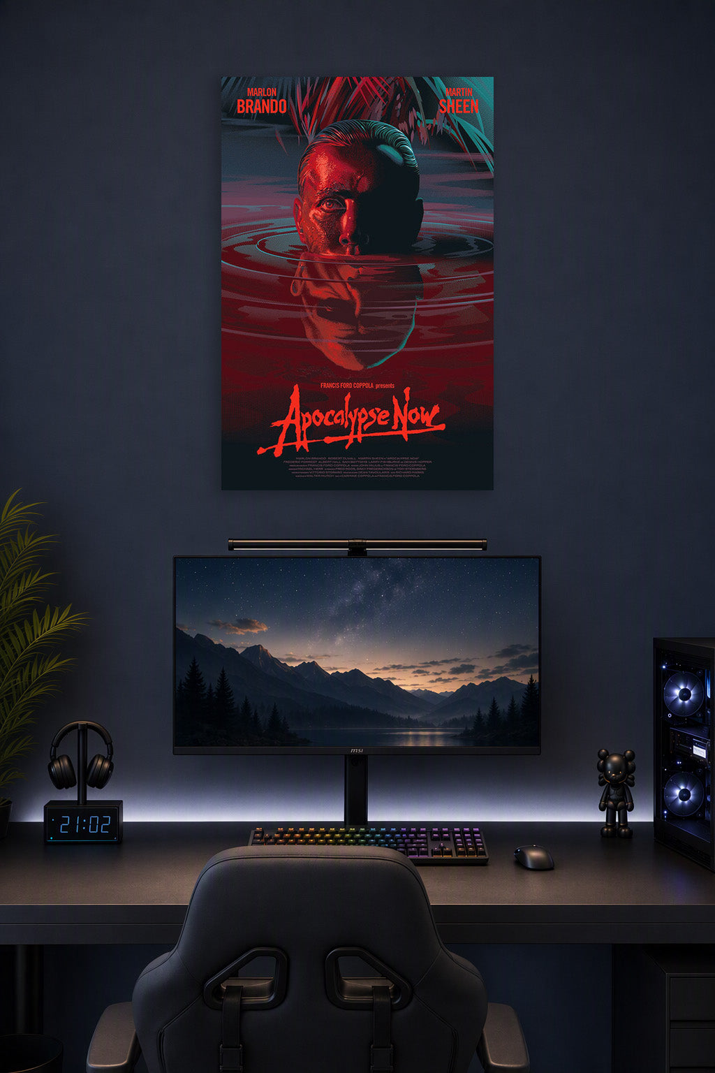 Apocalypse Now Movie Poster in a gaming desk setup above a monitor.