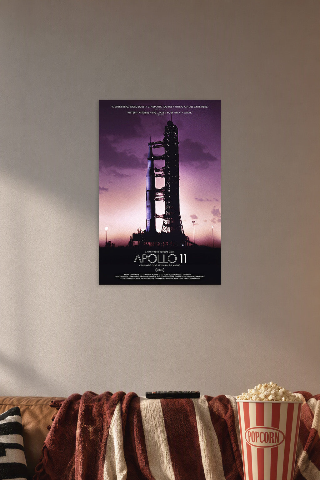 Apollo 11 Rocket Launch in a cozy movie room above a brown sofa with popcorn.
