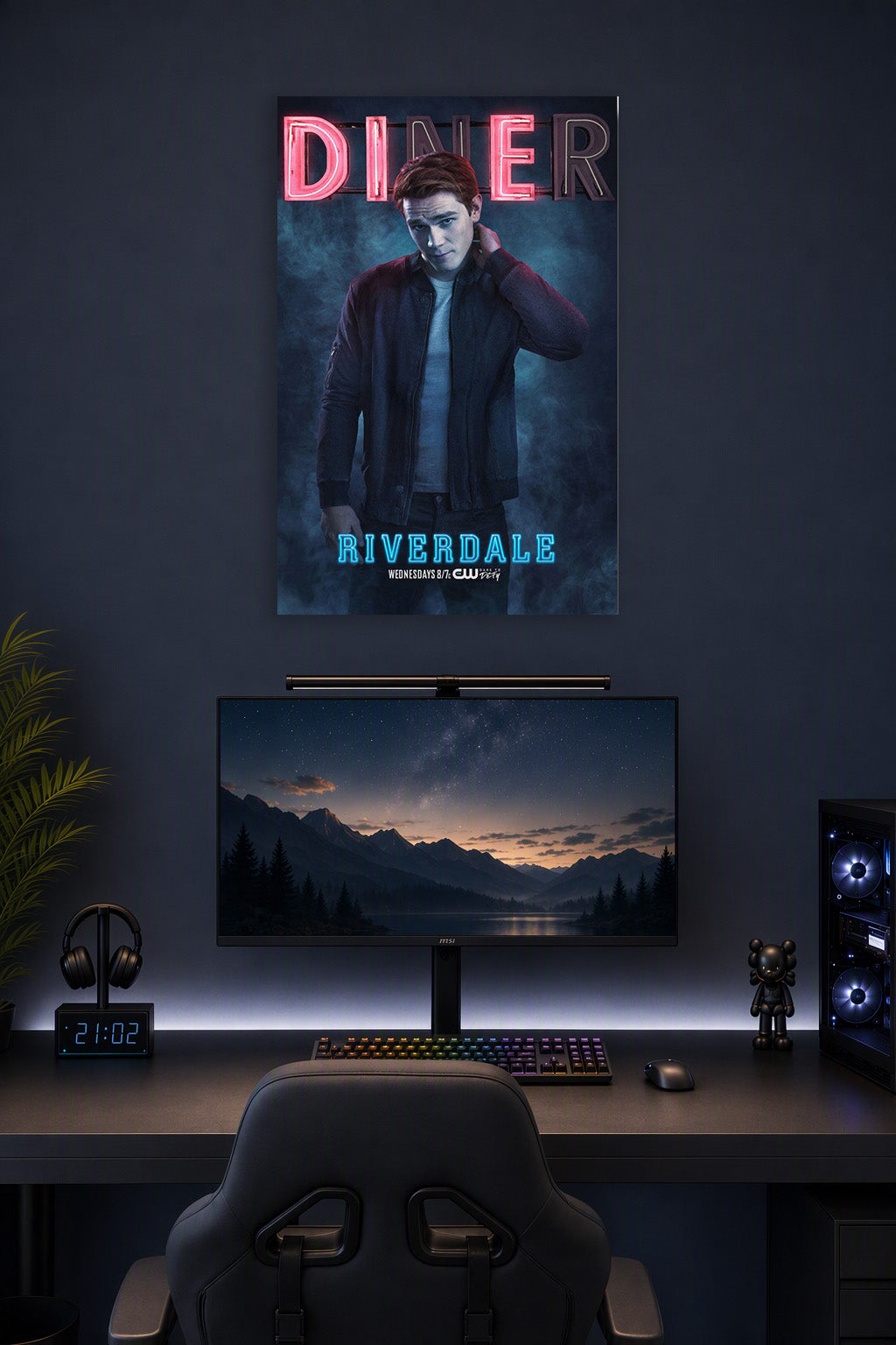 Archie Andrews Riverdale in a gaming desk setup above a monitor.