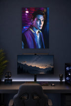 Archie Andrews Riverdale in a gaming desk setup above a monitor.